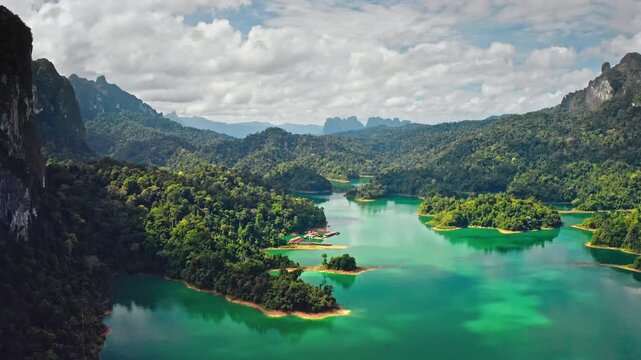 Cheow Lan Lake with its stunning turquoise water and limestone karsts, covered in lush green rainforest, serene and beautiful natural landscape in KHAO SOK National Park, Thailand. Rise up panorama