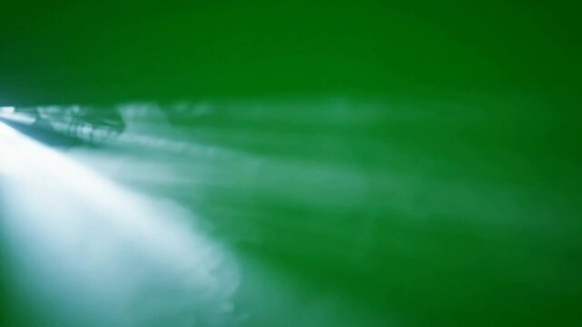 Volumetric light beams with atmospheric smoke on green screen background, volumetric lighting light rays