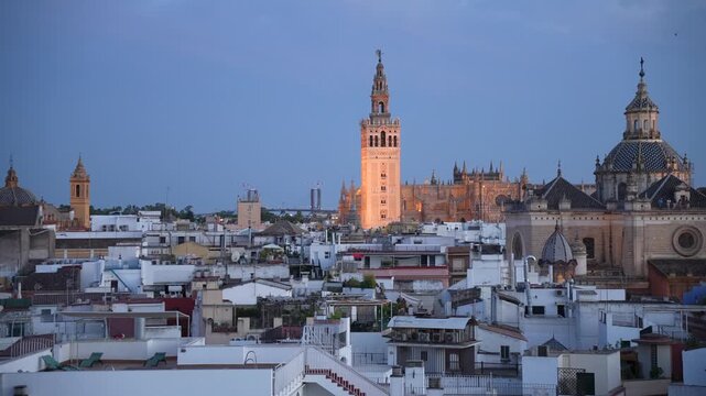 Elevated view of La Giralda and Cathedral of Seville at dusk, Seville, Andalusia, Spain