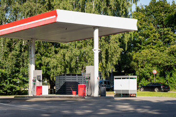 Wide view of a country petrol station showing the full canopy span and pump islands, the fixed infrastructure a rural community depends on for mobility. © K