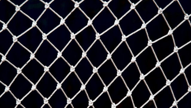 White fishnet wire pattern dark background