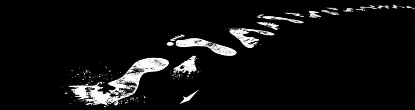 Set of human footprints isolated on a black background with footprints barefoot movement direction isolated background adventure conceptual footstep