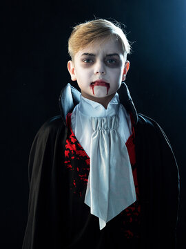 A boy dressed in a vampire costume