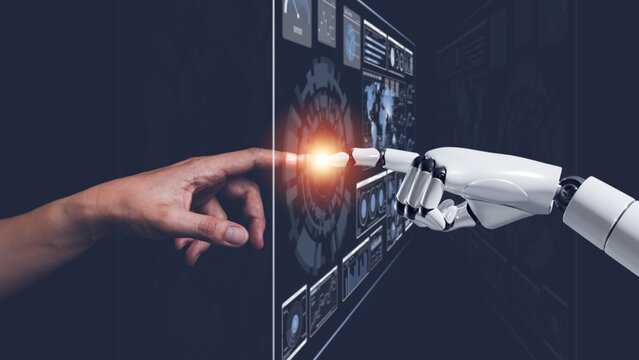 Human and robot hands connecting through digital interface, representing artificial intelligence, human AI collaboration, automation, robotics, machine learning, innovation and digital transformation.