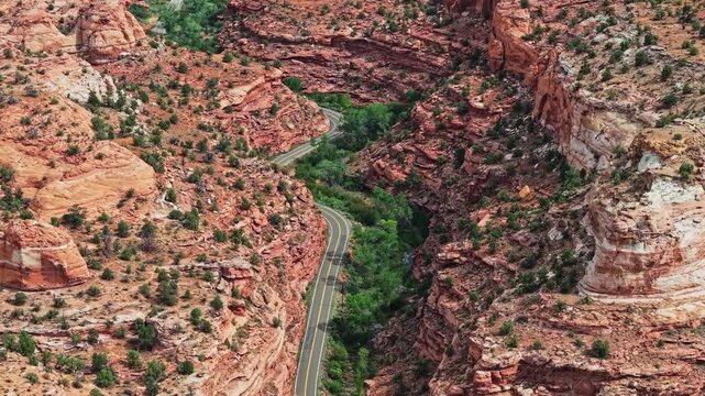 Aerial flight along winding Scenic Byway 12 through Escalante Canyons in Utah