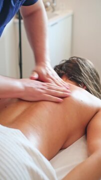 Professional care at a personal care studio focuses on back massage, a massage therapist, a woman, therapeutic massage, manual therapy, back treatment, and massage technique