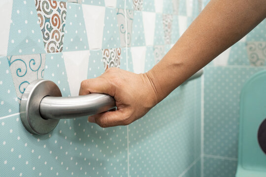Asian elderly woman use toilet bathroom handle security, healthy strong medical.