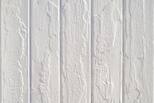Fresh white painted wood texture background with thick paint over rough uneven wooden boards