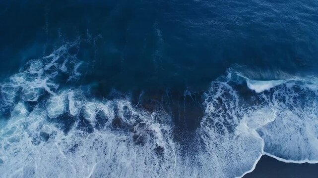 Aerial View of Ocean Waves Crashing on Sandy Beach, Deep Blue Sea