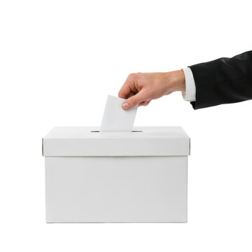 Person in a black suit jacket inserting a white ballot paper into a rectangular white cardboard voting box isolated on a transparent background