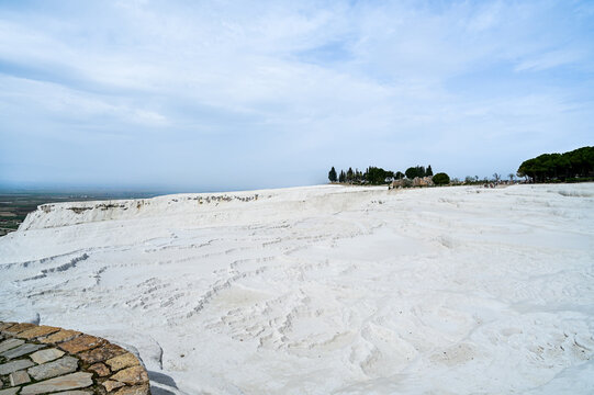 White travertine terraces of Pamukkale overlooking the lake near the town of Pamukkale a world-famous natural wonder and thermal springs Denizli Province, T&uuml;rkiye 