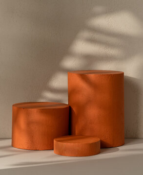Three terracotta textured cylinder product display podiums  against a beige textured wall with a dramatic leaf shadow overlay, suitable for cosmetic and beauty brand product staging.