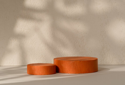 Product Presentation Scene made with Two Terracotta Cylinder Podiums with Diagonal Leaf Shadow on Beige Textured Background