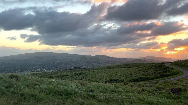Sunrise over the volcanic crater of Rano Kau on Easter Island, Chile. The rising sun illuminates the vast crater and Pacific Ocean, volcanic landscape