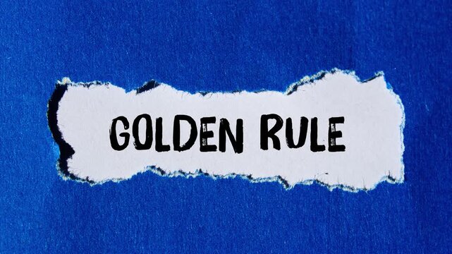Golden rule message writing on ripped torn paper background