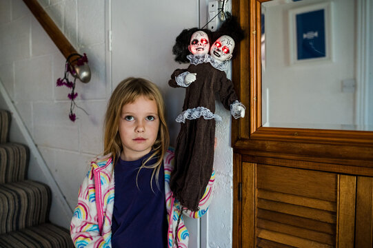 Spooky portrait of girl beside Halloween decoration