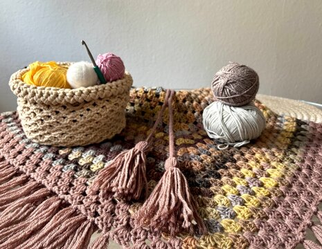 basket of yarn and cozy crochet blanket 