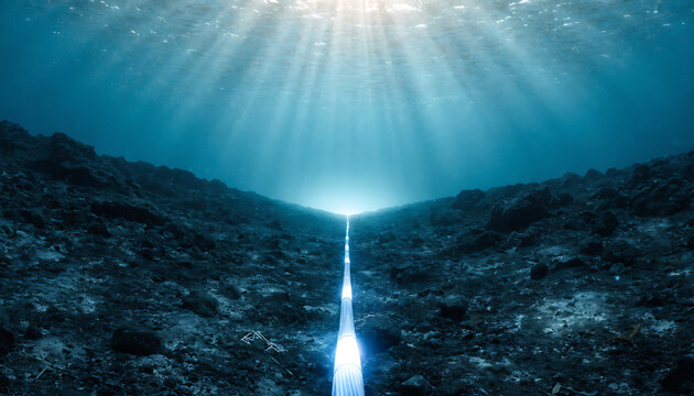 Underwater view of a deep ocean trench with bright light rays piercing the dark water