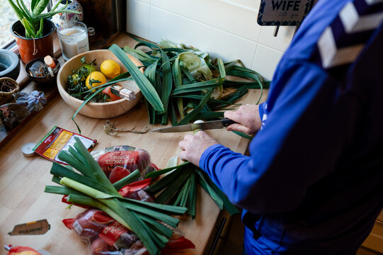Father preparing a meal with leeks grown at allotment