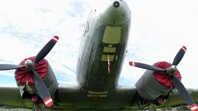 Close up drone shot of Douglas DC3 front cockpit and twin propellers on field