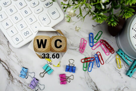 DG (Dynamic Goal) alphabet letters with calculator and alarm clock on marble background