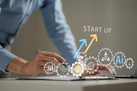 Startup growth concept with entrepreneur working on laptop and business strategy, featuring gears, AI and rising arrows. Startup, growth, innovation, technology, strategy