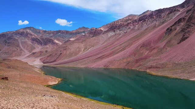 Aerial Drone View of Chandratal Lake in Spiti Valley, Himachal Pradesh with Crystal Blue Water, Rugged Snow Covered Mountains, Rocky Terrain and Vast Himalayan Wilderness