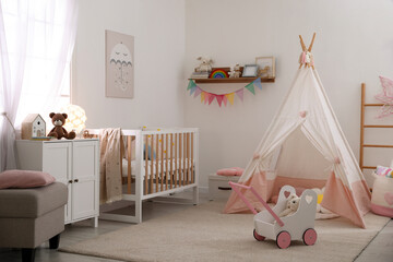 Crib, wigwam and other toys in baby's room. Interior design © New Africa