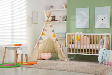 Cute baby room interior with comfortable crib, wigwam and other toys © New Africa