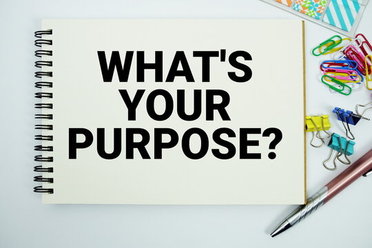 What's Your Purpose? text message written on notepad with stationery flat lay on white background