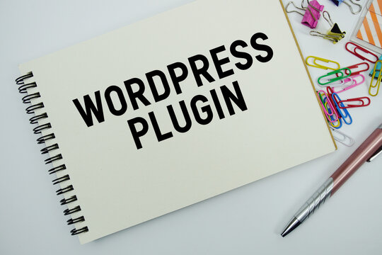 Wordpress Plugin text message written on notepad with stationery flat lay on white background