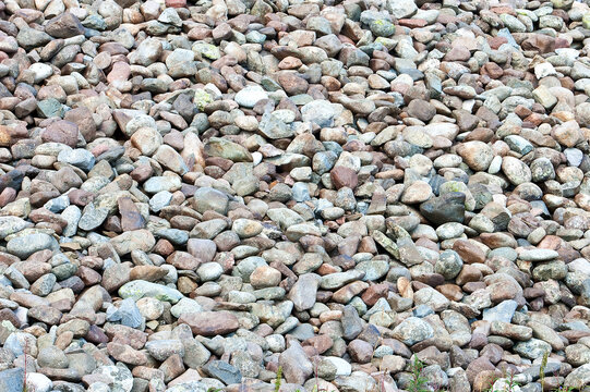 Natural pebble texture background with mixed rounded stones