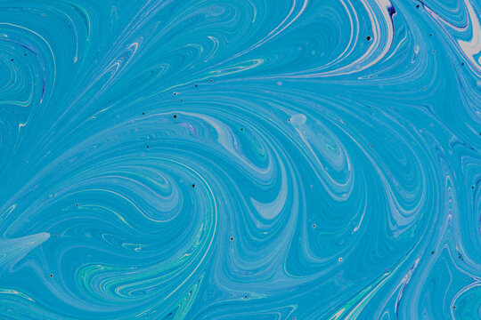 Full frame abstract blue and turquoise fluid paint texture. Marbling background with fine swirls.