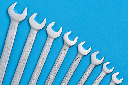 Set chrome vanadium spanners in ascending order on vibrant blue background. Mechanical tools.
