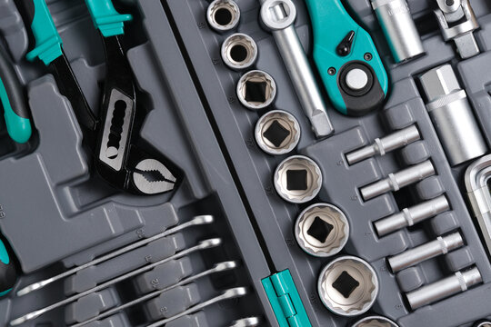 Angled macro view socket heads, water pump pliers, and ratchets arranged in organizer.