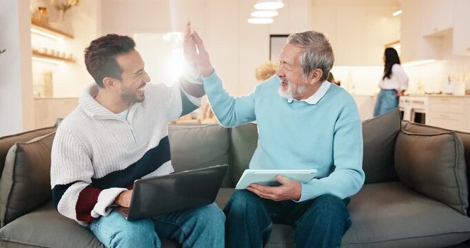 Dad, technology and adult son with high five in home for asset management or financial success. Elderly, senior father and man with laptop, tablet or lens flare on sofa for teamwork together in house