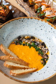 Pumpkin puree soup and sandwiches with seafood and soft cheese
