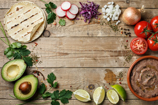 Fresh Mexican taco ingredients frame on rustic wood