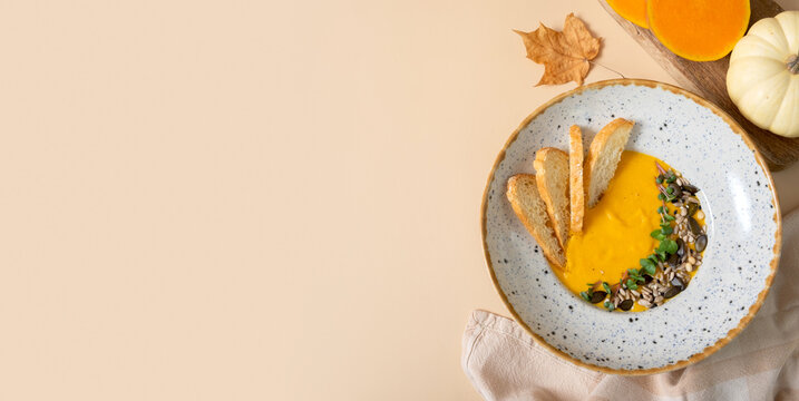 Pumpkin puree soup with croutons. Autumn menu top view, flat lay with copy space