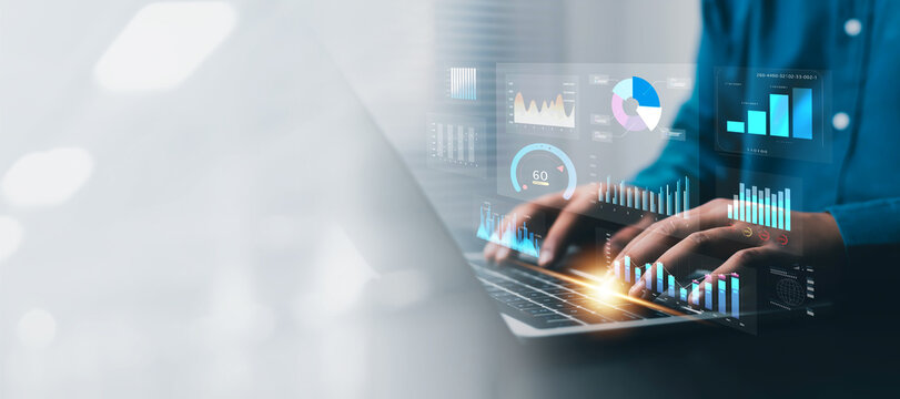 Business professional using a laptop with digital analytics dashboards, financial charts, data visualization, performance metrics, and business intelligence for modern strategy and decision making.