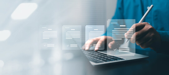 Business professional signing digital documents on a laptop with a stylus, representing electronic...
