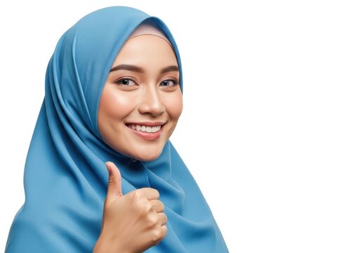 Smiling woman in blue hijab giving thumbs up