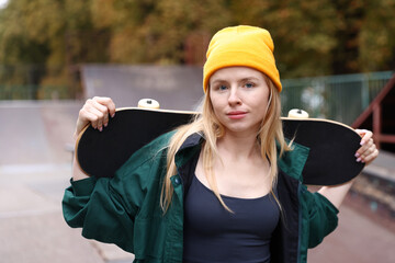 Stylish woman with skateboard in skate park © New Africa