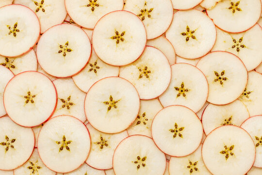 Thinly sliced apples with star shaped core.