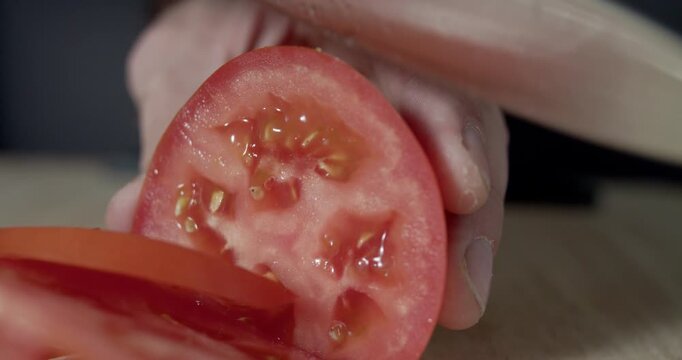 Macro wide close up of knife slicing and chopping a red tomato salad, food,