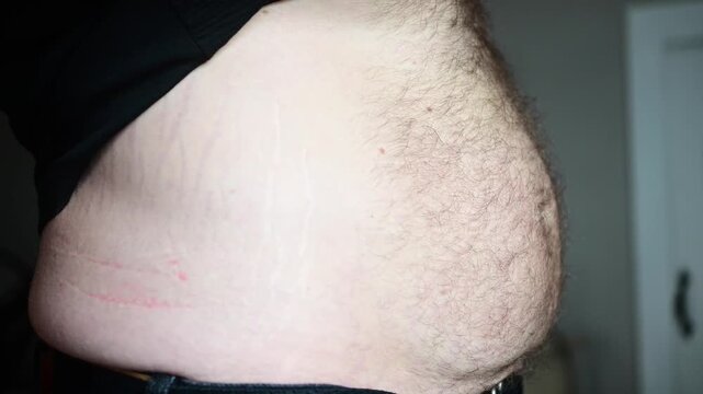 dad bod stomach flexing, man pregnancy theme