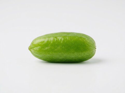 A single fresh green bilimbi fruit isolated on a clean white background