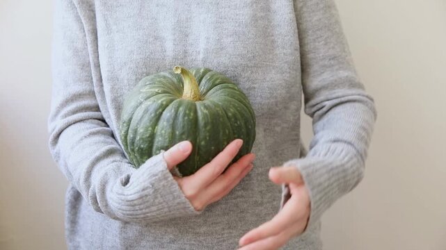 Autumnal moments mood. Unrecognizable woman holding autumn fall pumpkin in hands isolated on white background. Change of seasons ripe organic food concept, Halloween party Thanksgiving day