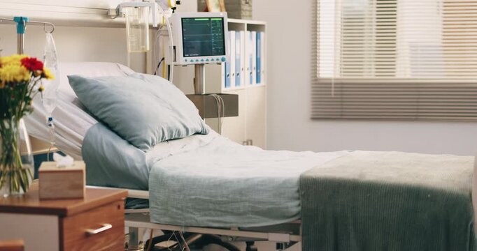 Empty, hospital and bed in room for medical, admission and inpatient care for surgery treatment. Interior, icu ward and flowers in facility with furniture, vital signs machine and healthcare services