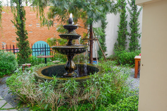 Luxury Fountain at green garden in house outdoor garden,Scenic View of a Beautiful English Style Landscape Garden in summer,selective focus.